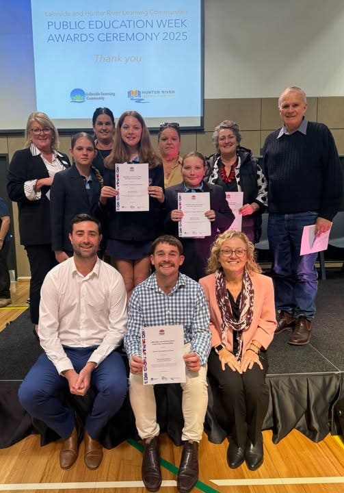 Photo of staff with students at assembly