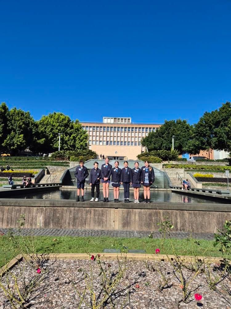 students standing on a wall
