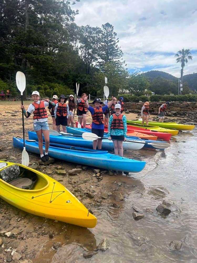 Group of students on the river with canoes